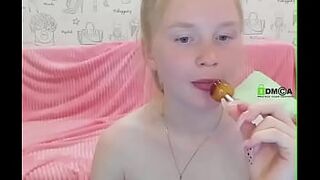 Young girl sucking lollipop