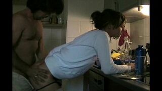 Couple having sex in kitchen